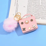 Load image into Gallery viewer, Mini Flower Wallet Keychain – Faux Leather Charm with Pom Pom &amp; Pearl Accents
