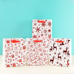 Load image into Gallery viewer, Merry charismas with reindeer and stars  stylish paper-bag for gifting.
