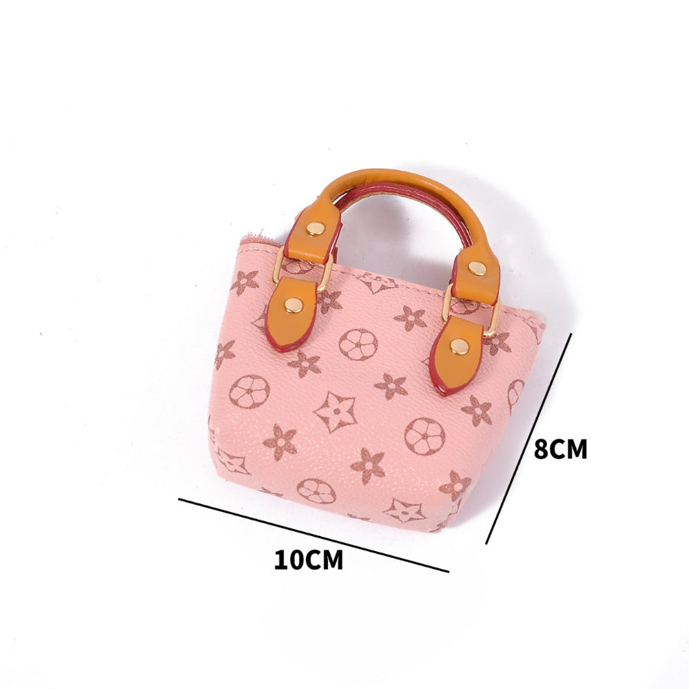 Pink mini handbag pouch with designer-style pattern and orange handles